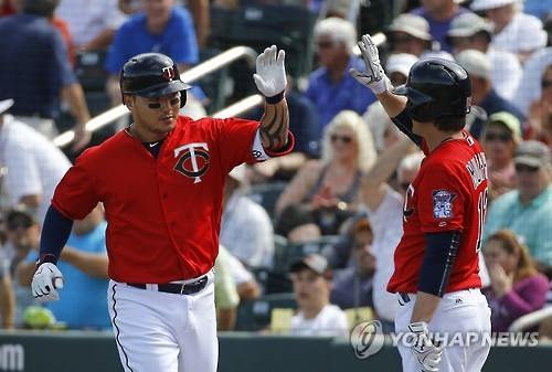 Park Byung-ho of the Minnesota Twins (L) celebrates with teammate John Ryan Murphy after hitting a solo home run against the Miami Marlins during their spring training game in Fort Myers, Florida, in this AP file photo taken on March 11, 2016. (Yonhap)