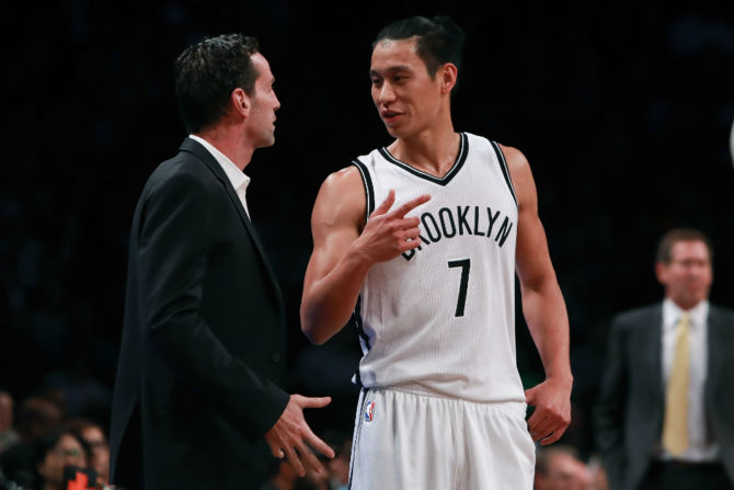  Jeremy Lin talks with coach Kenny Atkinson of the Brooklyn Nets against the New York Knicks during the first half of their preseason game at Barclays Center in New York City. [Image by Michael Reaves/Getty Images] 